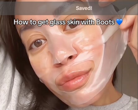 A woman peels a face mask off her face